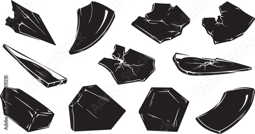 A collection of broken black crystal shards on white