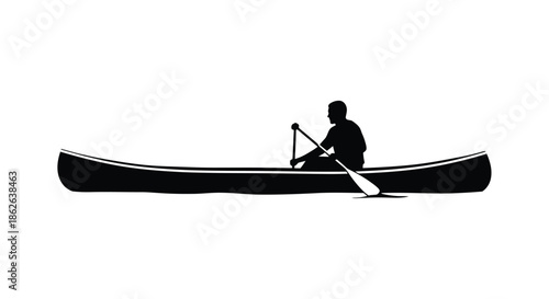 A solitary figure paddling a canoe on calm waters a stark black silhouette