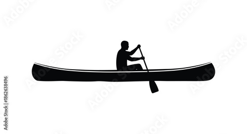 A lone paddler in a canoe navigates calm waters a striking black silhouette