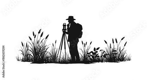 A surveyor with equipment amidst tall grasses a striking black and white silhouette