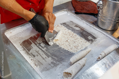 A person is making ice cream cones