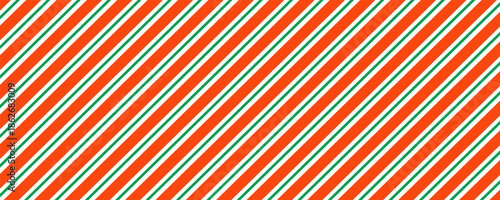 Christmas seamless pattern. Red and green diagonal stripes background. Candy cane repeating decoration wallpaper. Winter holiday lines backdrop. Xmas peppermint package wrapping print design. Vector