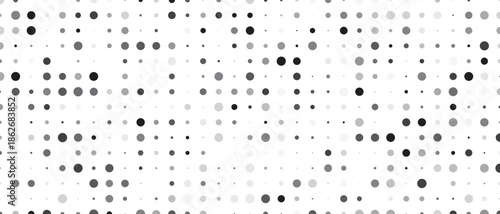 Abstract pattern of randomly sized and shaped dots and hexagons in grayscale