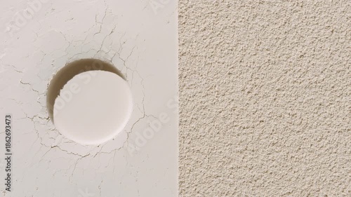 Top-down perspective shot of beige half flattened half sifted powder surface with small round imprint highlighted by orbiting light forming changing shadows | Ad concept for powder foundation