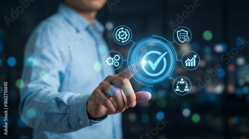 a man interacting with a futuristic digital interface displaying various icons representing quality assurance security and data analytics in a modern business setting