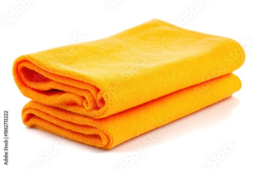Folded yellow towels on white background