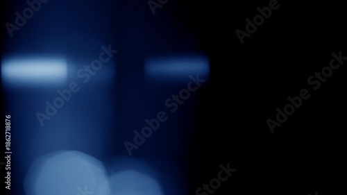 Cool cinematic light leak with a refractive flares flashing and traveling horizontally over a frame