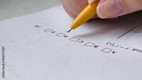 the student chooses the answer C in the exam and ticks the box. Exams at school, college, university.