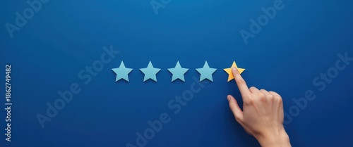 Customer satisfaction feedback with hand selecting four golden stars on a blue background