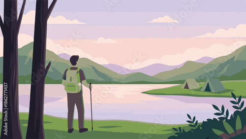 Hiker looking at mountain lake landscape with tents at sunrise or sunset