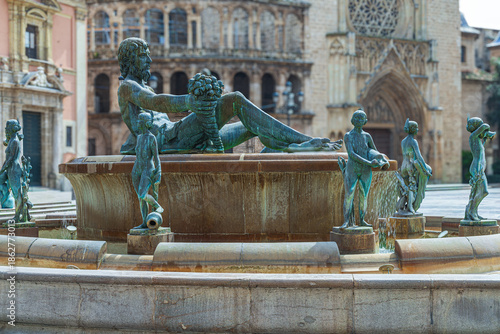 Turia Fountain located in the Plaza de la Virgen.Created by sculptor Silvestre Edeta, is a statue of the Roman god Neptune in center and sculptures of 8 naked women, Valencia, Spain