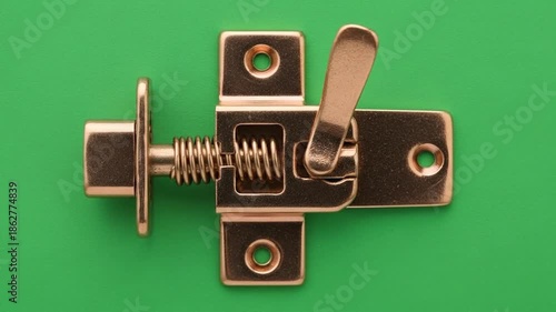 Close-up of a Spring Latch on Green Background.