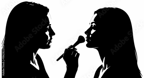 Silhouette of makeup artist applying makeup to a woman with a brush technique
