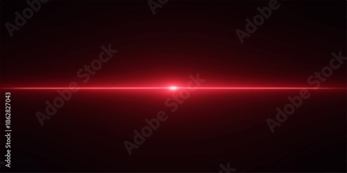 Bright red light beam shining horizontally across a dark background