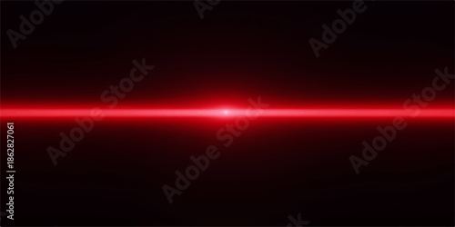 Bright red laser beam shining against a dark background