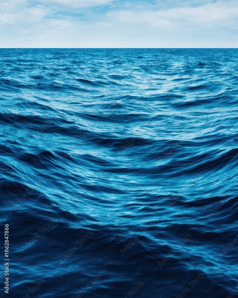 Fototapeta premium Blue Monday Vertical view of deep blue churning ocean water extending towards the horizon under a pale sky