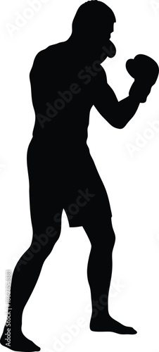 Dedicated male boxer in athletic shorts stands ready for a rigorous training session