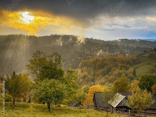 Sunny Autumn Carpathians with Puffy White During The Sunset