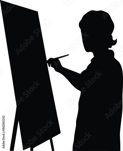 Focused artist silhouette creating a new masterpiece on an easel with a paintbrush