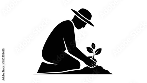 a person in a hat is planting a sapling in the ground in black silhouette