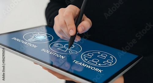 Person Using Stylus on Tablet Displaying Business Icons for Innovation, Solution, and Teamwork.