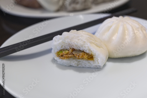 Traditional Chinese dim sum featuring soft, fluffy steamed pork buns ,Salapao, perfect for themes of oriental cuisine, snacks, or breakfast.