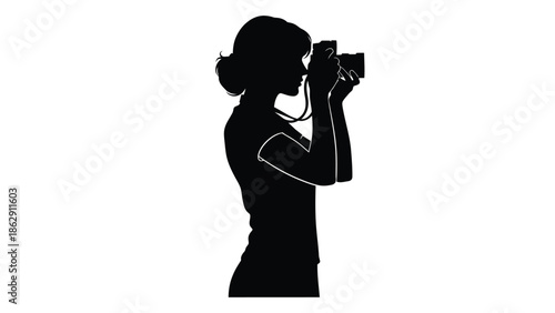 Silhouette of a woman holding a camera focused on photography
