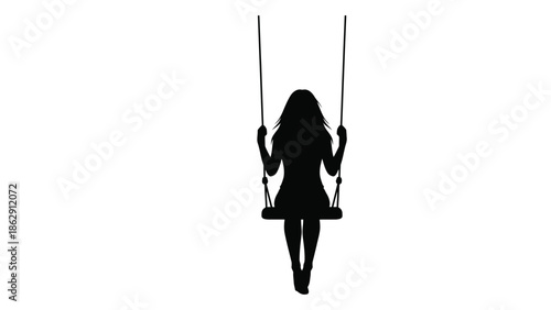 A solitary figure silhouetted on a swing evoking feelings of peace and reflection