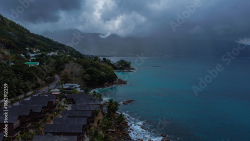 Dramatic Tropical Coastline Under Heavy Rain Clouds and Stormy Sky