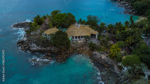 Unique Coastal Property on Rocky Peninsula: Aerial View of Tropical Oceanfront Home and Bay