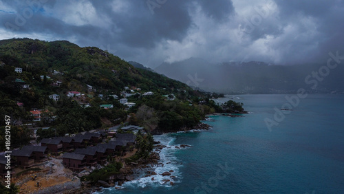 Exotic Coastal Scenery: Hills and Homes Leading Down to the Sea Under Rainy Conditions