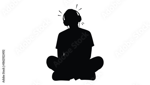 Silhouette of a person meditating with headphones in a peaceful pose
