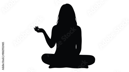 Silhouette of a woman peacefully meditating in a seated lotus position