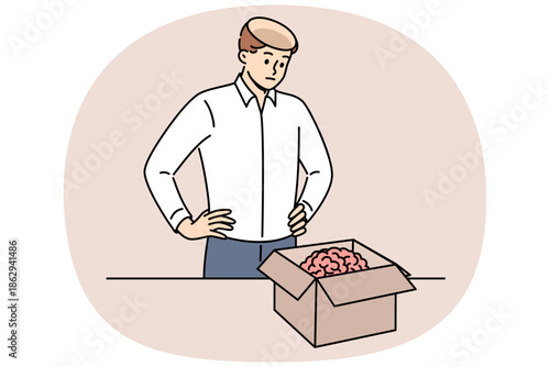 Man took brain out of head and put it in cardboard box, for concept of removing facts from memory. Stupid guy received new brain in package to quickly become smarter and acquire new skills