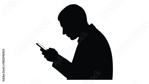 Silhouette of a person intently looking at their mobile phone
