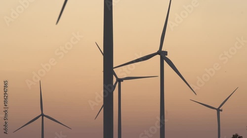 A silhouette video of wind turbines at sunset.
