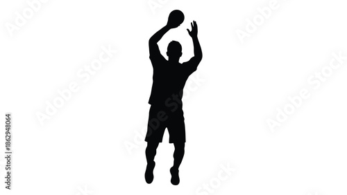 Silhouette of an athlete reaching for a basketball in mid air