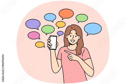 Woman shows off messages pointing fingers at phone and calling for downloading new mobile messenger. Girl smiles standing among dialogue clouds symbolizing exchange of messages on social networks.