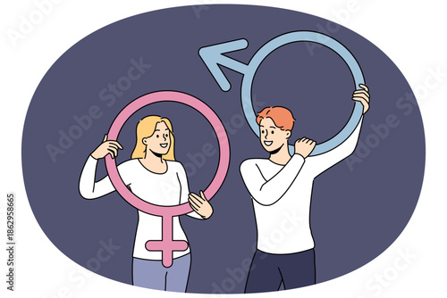 Couple of man and woman hold gender badges and smile, feeling respect for opposite sex. Gender symbols in hands of people rejoicing in absence of discrimination and universal equality