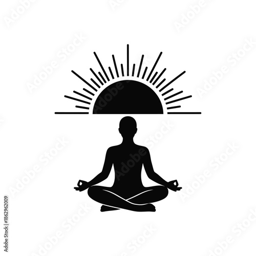 Black silhouette of a person meditating in lotus position under sunrise