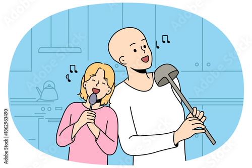 Hairless boy and little girl sing standing in kitchen, use utensils instead microphone, imagine visit in karaoke. Sister supports brother dreams of going to karaoke after undergoing cancer treatment