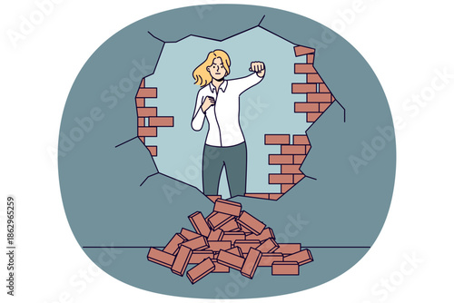 Strong woman breaks down barriers to business success by making hole in brick wall. Ambitious business lady moves forward eliminating troubles and wanting to develop in difficult situation.