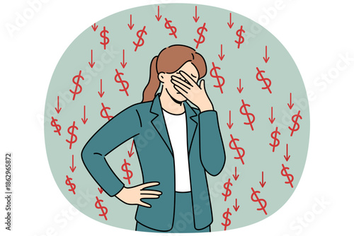 Businesswoman who is victim of financial crisis covers eyes with hand, standing among dollar signs and downward arrows. Girl feels stressed due to onset of financial crisis caused by recession.
