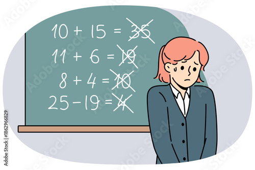Upset schoolgirl stands near blackboard, sad because of mistakes in solving mathematical examples. Schoolgirl does not have necessary knowledge due to poor curriculum or low-quality education system
