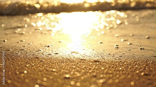 Sun Dazzled Seascape beach sparkle summer Medium shot across a serene summer beach towards the ocean, capturing the vast expanse of the water's surface shimmering brilliantly under a high sun.