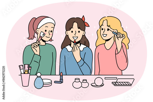 Little girls do makeup using lipstick and mascara or powder to prepare for school party. Schoolgirls want to be like mothers and put on makeup, getting ready to date boys from classmates.