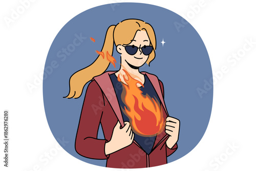 Inspired woman with flame in breast unbuttons jacket demonstrating ambition and desire to achieve goals. Cool girl in sunglasses, ready to demonstrate ambition and complete complex business tasks