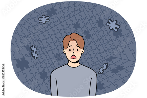 Depressed man screams during panic attack or hallucination, standing among collapsing puzzle. Guy with personality disorder needs help psychologist to get rid panic attacks and restore mental health