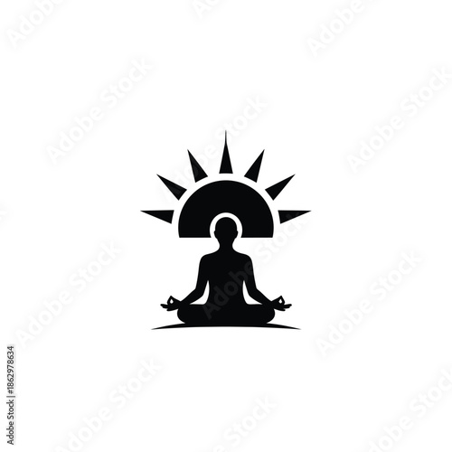 Black silhouette of person meditating in lotus position under sun