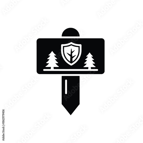 Black silhouette signpost with shield and trees